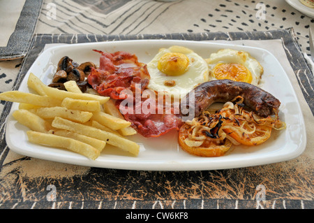 South African breakfirst con patatine fritte, funghi e pancetta, uova fritte, salsicce di pesce e pomodori, Sud Africa Foto Stock