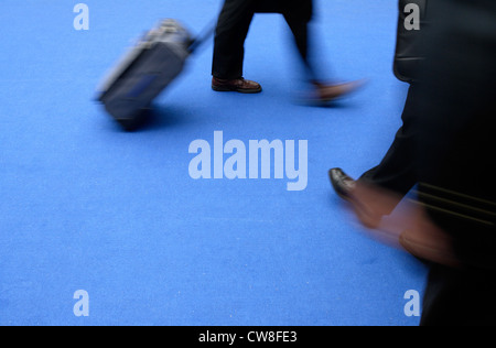 La gente di affari si cammina su un tappeto blu Foto Stock