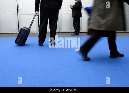 La gente di affari si cammina su un tappeto blu Foto Stock