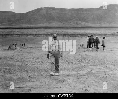 Generale Leslie Groves (1896-1970), attraversando a piedi il sito della prima bomba atomica sito blast a Alamogordo, N.M. in luglio Foto Stock