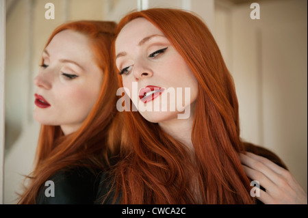 Bella giovane donna con la sua riflessione a specchio Foto Stock