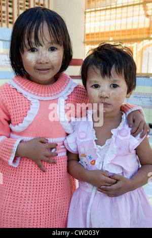 Myanmar Birmania. Mandalay. Due piccole bambine birmane. Che indossano thanaka incollare sulle loro facce, di un cosmetico sunscreen. Foto Stock