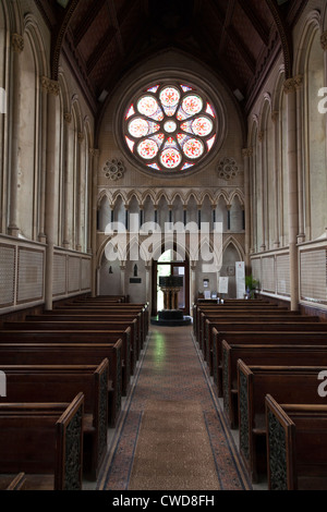 Interno della chiesa di Santa Maria a Itchen Stoke con vetro colorato di rosa e la finestra Font Foto Stock