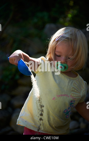 Bambino ragazza bionda baby il gioco con la sabbia in sandbox Foto Stock