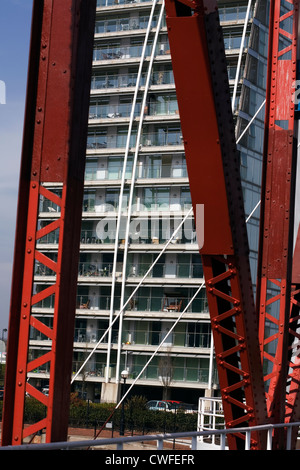 NV edifici moderni blocchi di appartamenti visto attraverso le travi del ponte girevole Huron Basin Salford Quays Greater Manchester Inghilterra England Foto Stock