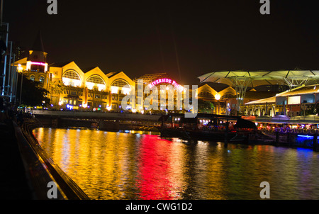 Luci scintillanti e la riflessione in acqua di fiume in Clarke Quay a Singapore. Sembra incredibile di notte, con tutte queste luci Foto Stock