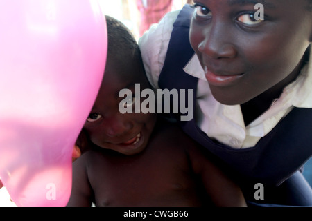 I bambini dello Zambia con palloncino rosa, Mwandi, Zambia nei pressi di Livingstone. Foto Stock