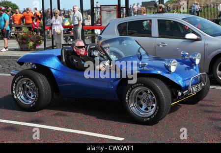 L uomo e la donna nel luminoso blu metallico kit car visto all'interno di Tynemouth North East England Regno Unito Foto Stock