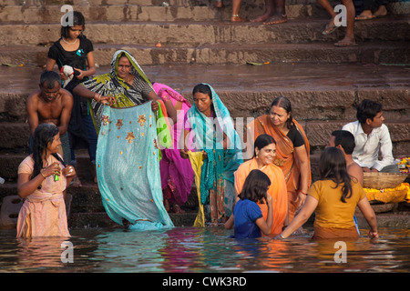 Le donne indiane di balneazione in acque inquinate del fiume Gange a Varanasi, Uttar Pradesh, India Foto Stock