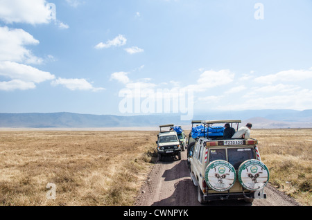 NGORONGORO AREA CONSERVATIONAL, Tanzania - Safari veicoli fermi a guardare wildelife al cratere di Ngorongoro in Ngorongoro Conservation Area, parte della Tanzania settentrionale, al circuito di parchi nazionali e la natura conserva. Foto Stock