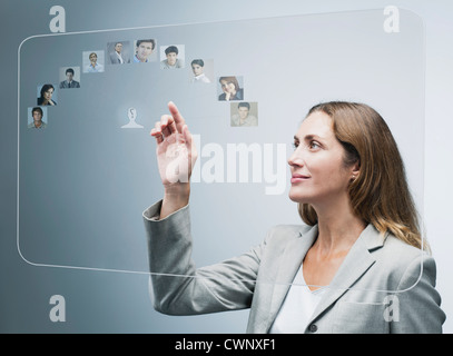 Responsabile delle risorse umane di valutare i candidati su avanzate interfaccia touch-screen Foto Stock