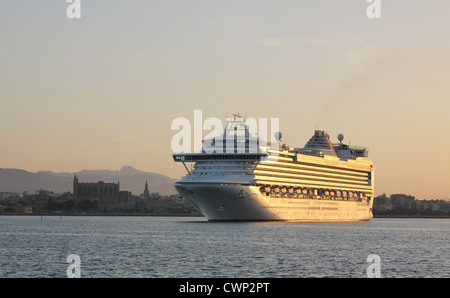 Cunard Line nave da crociera "Azura" arrivando alla mattina presto nel porto di Palma de Mallorca - con Palma storica cattedrale su Foto Stock