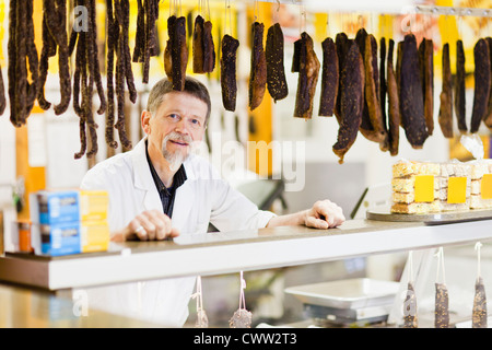 Butcher permanente al contatore di carne Foto Stock