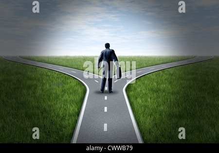 Business man in corrispondenza di un incrocio di strade in piedi in un orizzonte con erba e cielo blu che mostra una biforcazione della strada che rappresenta il concetto Foto Stock