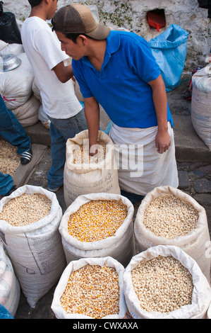 Persone che acquistano il mais fornitore nel mercato locale, Chichicastenango, Guatemala. Foto Stock