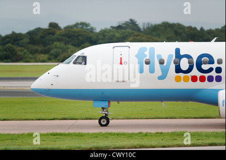 Un Flybe Embraer 190 di rullaggio sulla pista dell'Aeroporto Internazionale di Manchester (solo uso editoriale) Foto Stock