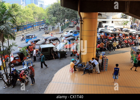Pendolari Giavanese e attesa di autisti di tuk tuk a stazione ferroviaria di Gambir a Jakarta, Indonesia. Foto Stock