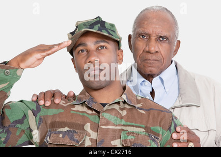 Ritratto di US Marine Corps soldato con padre salutando su sfondo grigio Foto Stock