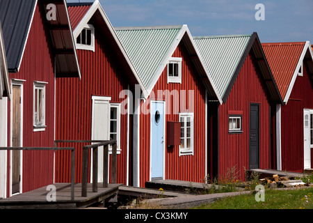 Rosso barca in legno capanne nel porto di Hamburgsund, Bohuslän, Svezia Foto Stock