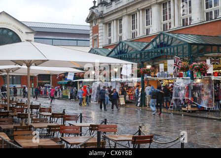 People shopping sotto la pioggia al Giubileo Market Hall. Il Covent Garden. Londra. In Inghilterra. Foto Stock