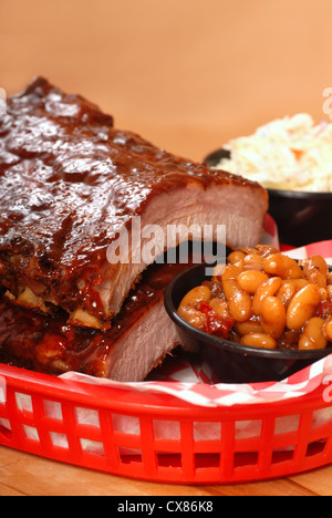 Delizioso BBQ Ribs con fagioli, cole slaw e una piccante salsa barbecue Foto Stock