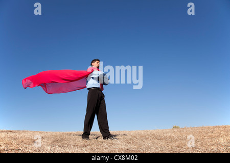 Imprenditore con un rosso battenti cape come superman Foto Stock