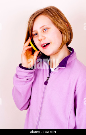 Dieci anni di ragazza utilizzando un telefono cellulare Foto Stock