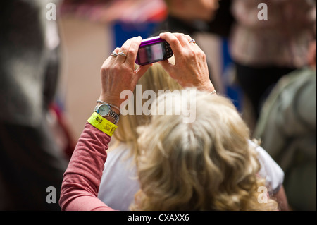 Signora anziana prendendo foto con una fotocamera digitale a Abergavenny Food Festival Foto Stock