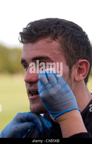 Giocatore di Rugby ricevono cure mediche durante il gioco, Farnham, Surrey, Regno Unito. Foto Stock