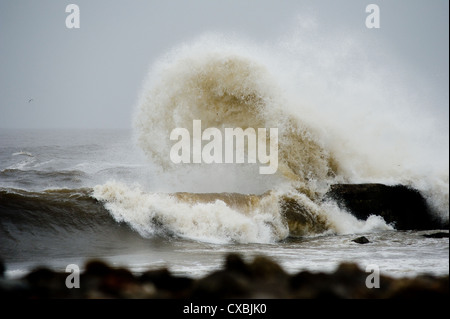 Onde infrangersi sulle rocce in una zona conosciuta come Sud gare su Teesside in Inghilterra come mareggiate ancorare il litorale. Foto Stock