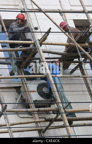 Shanghai, lavoratori edili su un Bambusgeruest Foto Stock