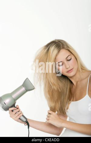 Teen ragazza con asciugacapelli Foto Stock