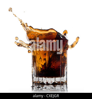 Splash di cola in vetro isolato su bianco Foto Stock