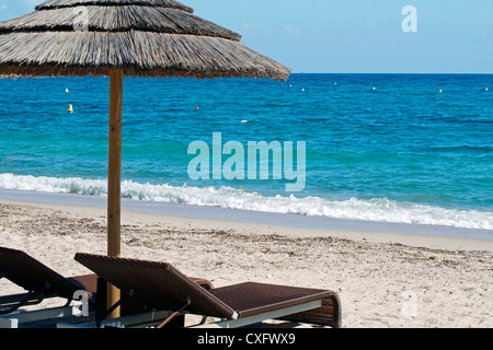 Vista di due sedie e ombrellone in spiaggia Foto Stock