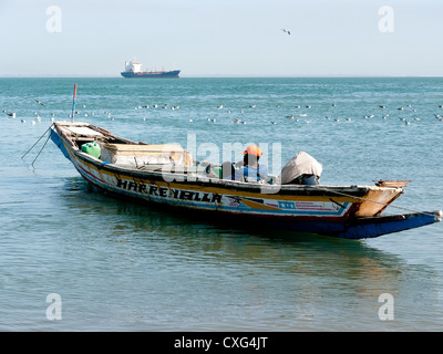 Uomo in una barca da pesca di ostriche al Denton Bridge, la Gambia, Africa occidentale Foto Stock