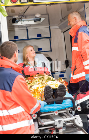 Soccorsi di emergenza con feriti donna in ambulanza sulla barella Foto Stock