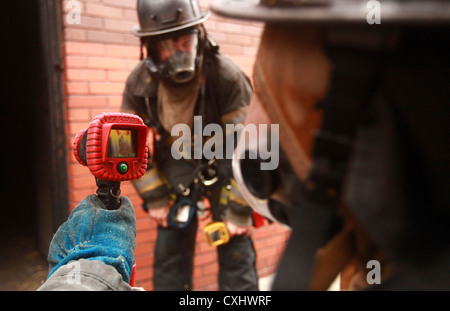 New york - Peter park, un residente di champaigne, ill. e un veterano marini ospitati dalla semper fi fondo, utilizza una telecamera termica per trovare un incendio durante un evento di formazione detenuti per i combattenti feriti, gestito da Active vigili del fuoco, che sono anche i veterani di marino. un gruppo di guerrieri feriti hanno visitato la città di new york fire Accademia situato su randall's island su sept. 29. Foto Stock