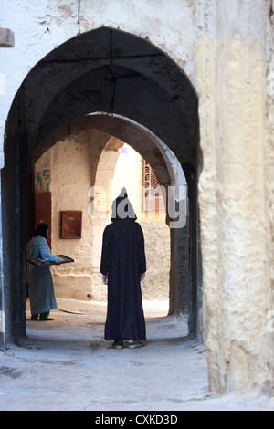 Giovane uomo in abiti tradizionali in piedi in modo arco, Safi, MoroccoSafi, Marocco Foto Stock
