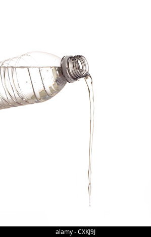 A bottle of water being poured out on a white background with copy space Foto Stock