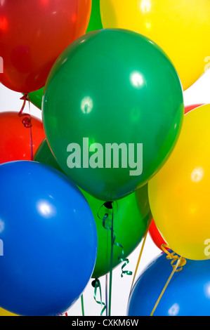 Principale partito colorato di palloncini con nastri su sfondo bianco Foto Stock