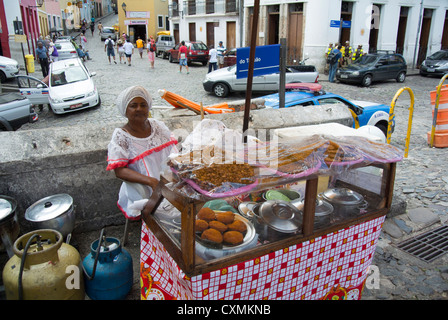 Salvador de Bahia, Brasile, donna locale che vende cibo anima in stand in strada Foto Stock