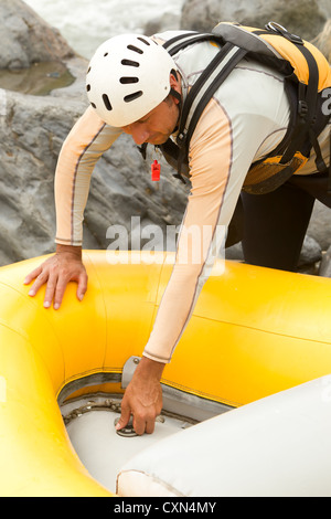 Rafting manutenzione barca pilota di preparare la barca per la prossima avventura Foto Stock