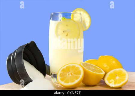 Bicchiere di limonata fatta in casa con un fresco e limone e zucchero nella parte anteriore del cielo blu sullo sfondo Foto Stock