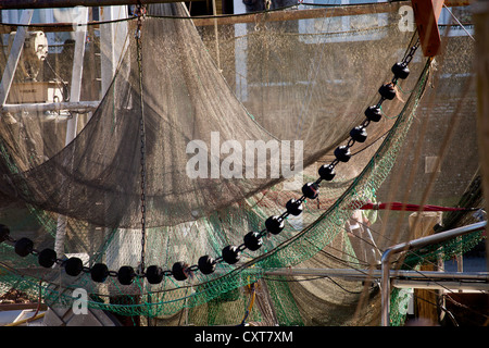 Al netto di una barca da pesca appesa ad asciugare nel vecchio porto da pesca di Neuharlingersiel, Frisia orientale, Bassa Sassonia, Germania Foto Stock