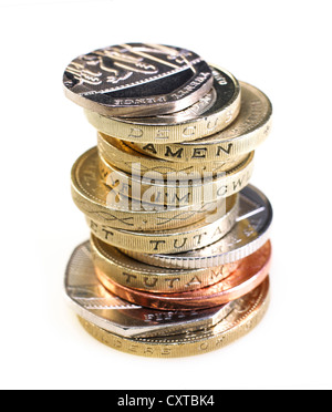 Pila di monete Britanniche shot su sfondo bianco Foto Stock