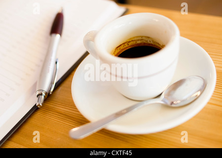 In prossimità della tazza di caffè, piattino e cucchiaio Foto Stock