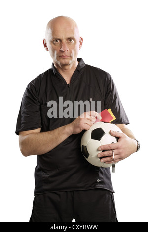 Arbitro tenendo un calcio e rosso e cartellini gialli Foto Stock