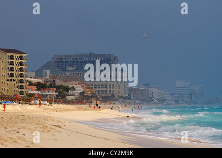 La spiaggia e il surf in Cancun Messico sotto uno scuro, cielo minaccioso Foto Stock