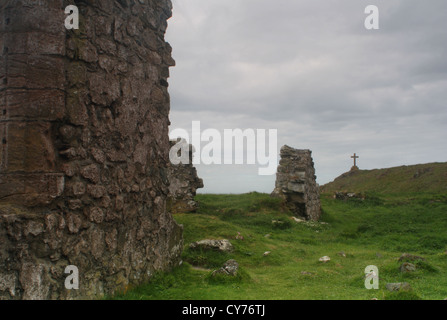 St Dwynwens rovine della chiesa e la croce sulla isola Llandwynn Anglesey Foto Stock