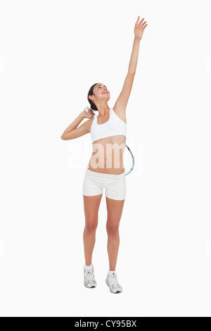 Slim donna giocare a tennis in bianche vesti Foto Stock